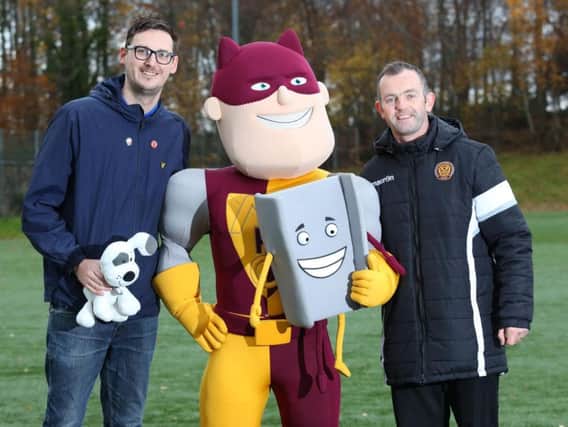 Andy Ross (left) and MFC community coach David Clark (right) with mascot Steelman