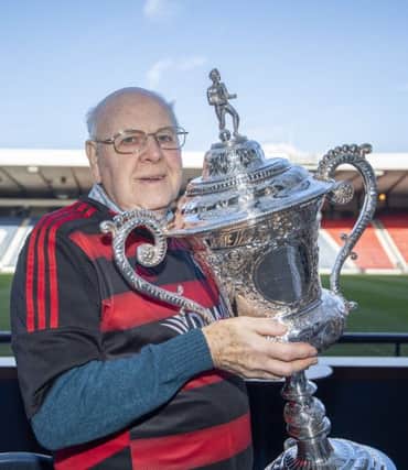Back in safe hands...Ian Dyer was reunited with the junior cup he last lifted back in 1962 when he was captain of the successful 
11961-62 Kirkintilloch Rob Roy FC team.
(Pic: Graeme Hunter)
