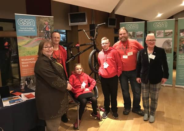 Dan Scott and Fred Crowson from Social Track, Jayme Leigh Halford from Berryhill Primary and Logan Kirk from Clyde Valley High are joined by Clare Adamson MSP and Councillor Agnes Magowan as the work of Wishawhill Wood Pump Track is showcased at the Scottish Parliament