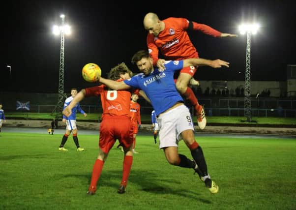 Raymond Grant of Clyde, left, Cowdenbeath's Kris Renton and, in the air, Clyde captain Kevin Nicoll (Craig Black Photography).