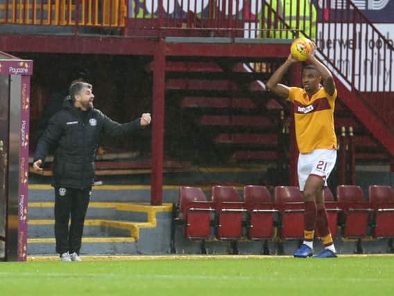Motherwell manager Stephen Robinson (left) let rip after alleged racial abuse of Christian Mbulu (also pictured)