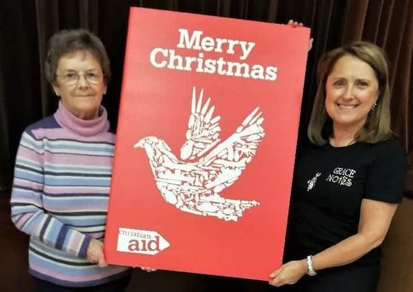 Left to right: Iris Nelson and Janis McBride, members of St Johns church holding the card.