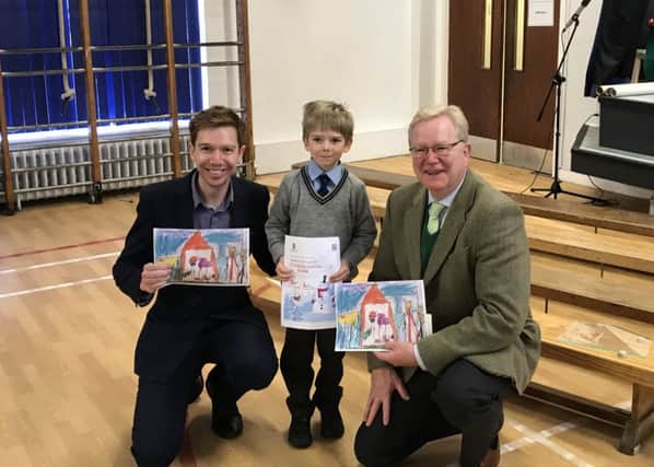 Paul Masterton MP and Jackson Carlaw MSP pictured at St Josephs Primary School with Christmas Card competition winner Oliver Sass.