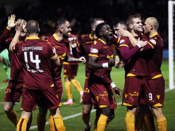 Chris Cadden is mobbed by jubilant Motherwell team-mates after netting the clinching goal in the Steelmen's 2-0 success at St Mirren on October 31 (Pic by Ian McFadyen)