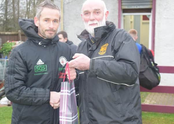 Stewart Maxwell receives a gift from Kilbirnie president Ian MacDonald before Saturdays game.