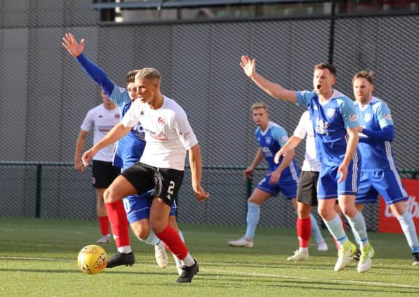 Tom Lang in action against promotion rivals Peterhead