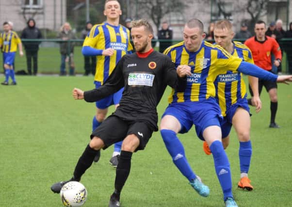 Steven Seatomn holds off the Hurlford defenders during Saturday's cup tie (pic by HT Photography/@dibsy_)