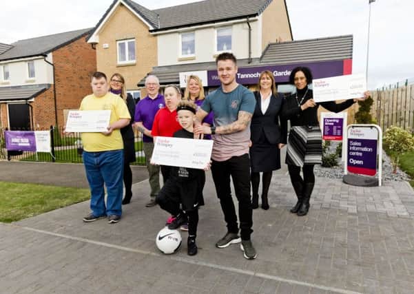 The three Community Chest winners from Viewpark receive their cheques at Taylor Wimpeys Tannochside Gardens development