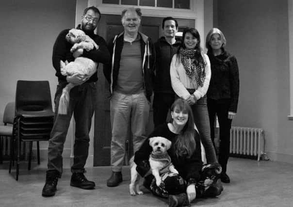 From left: Director Michael Emans with The Twelve Pound Look cast members Tom Hodgkins, Steven Scott Fitzgerald, Jo Freer and Julia Watson, with designer Lyn McAndrew (on floor) and dogs Benji and Teddy.