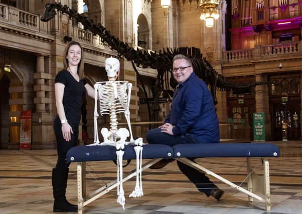 Derek Leitch, owner, and Laura Sutherland, chiropractor at Clarkston Chiropractic, with Dippy at Kelvingrove Museum. Photo: Gary Hutchison.