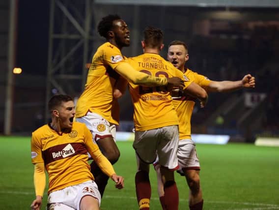 Gboly Ariyibi (second left) thinks Motherwell harbour realistic top six ambitions this season (Pic by Ian McFadyen)
