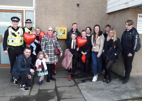 Heather Liengie (tartan coat) from Mossend fundraised for the defibrillator which she has dedicated to her son Mark who died suddenly from cardiac arrest in 2001