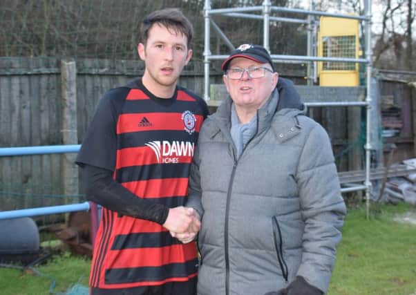 Joe Slattery receives his Man of the Match award, donated by Roddy the Dog Walker, from sponsor Charlie OBrien after Saturdays game.