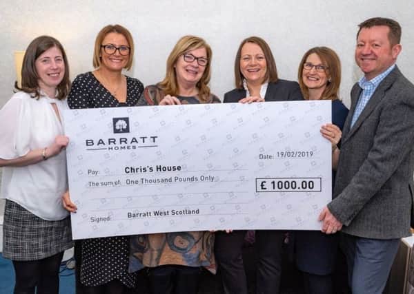 Chriss House founder  Anne Rowan (centre, left) was delighted to receive the cheque from the Barratt Homes Community Fund