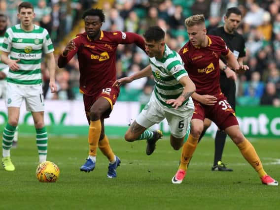 Motherwell's Gboly Ariyibi (left) scored Motherwell's controversial opener at Celtic Park after the initial shot by James Scott (right) had been saved (Pic by Ian McFadyen)