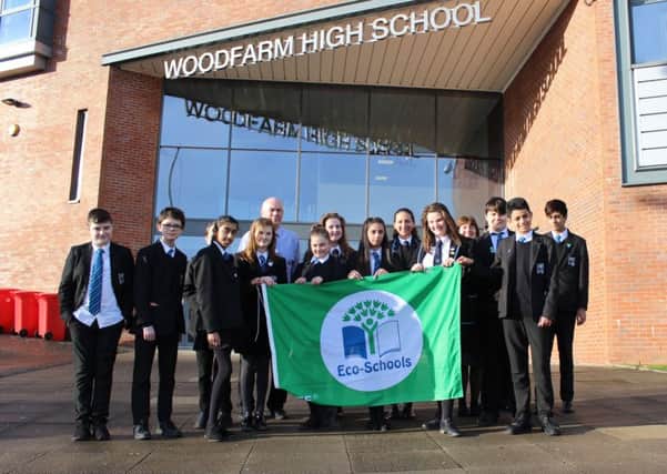 Proudly pictured with their new flag are Woodfarm High School pupils who have been heavily involved in the schools extensive eco-work.