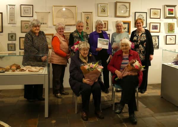 Members of Biggar Embroirdery Guild are staging an exhibition in conjunction with the Scottish Diaspora Tapestry at New Lanark, celebrating the group's 40th anniversary.
 And they recently toasted long-serving members at a celebration lunch at the World Heritage Site.