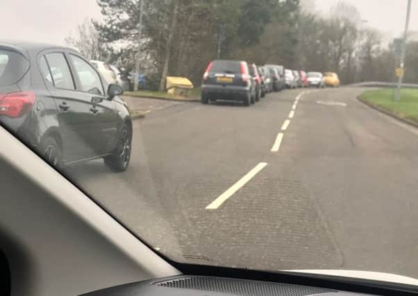 The long row of parked cars on Island Road in Seafar which forces other vehicles to drive on the wrong side with a bend up ahead