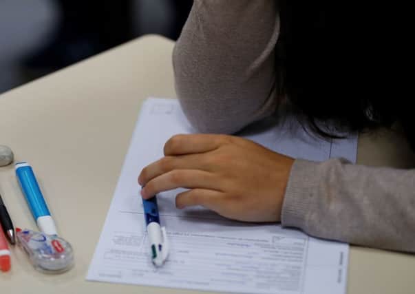 An high school student waits for the start of an exam. Pic: CHARLY TRIBALLEAU/AFP/Getty Images)