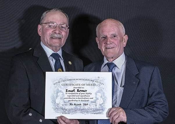 Lanarks green-fingered Ernie Romer (right) accepts the award from the Societys George Anderson.