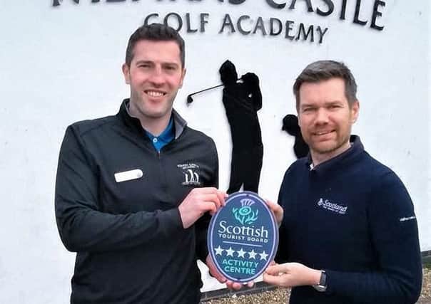 Russell Gray (left), operations manager at Mearns Castle Golf Academy, accepts the Quality Assurance Five star accolade from Gordon Smith, VisitScotland regional director.  (Photo:VisitScotland)