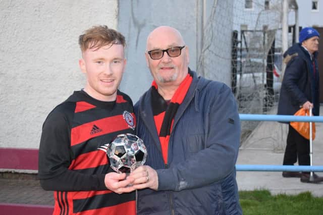 Lee Gallacher receives the Supporters Man of the Match trophy, donated by Roddy the Dog Walker, from sponsor John McKean