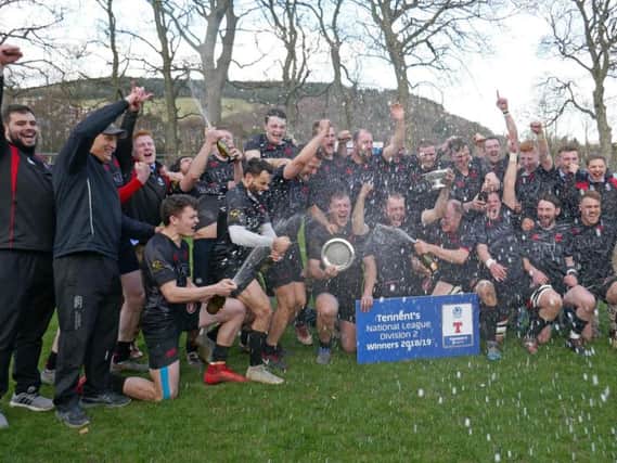 Biggar Rugby Club head coach Gary Mercer (2nd left) celebrates this seasons runaway Tennents National League Division 2 title success with his jubilant squad (Pic by Nigel Pacey)