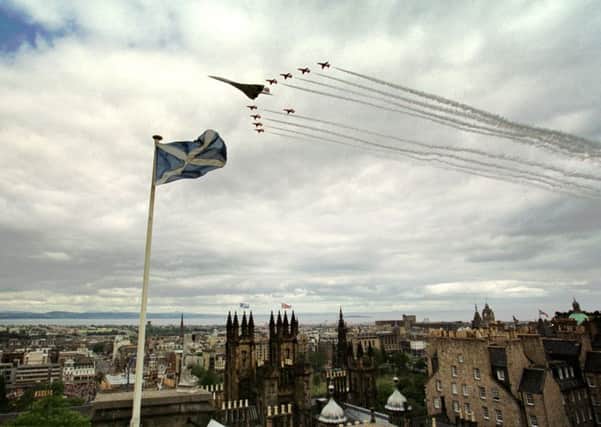 The Red Arrows and Concorde flew over Princes Street Gardens in Edinburgh on July 1, 1999, after the Queen officially opened the Scottish Parliament. This picture was taken by David Moir from the outlook tower and camera obscura at Castlehill.