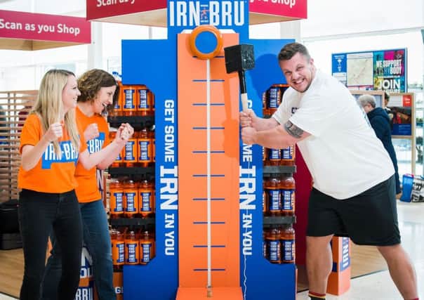 Luke Stoltman tests his strength on a visit to Tesco Extra in Cumbernauld