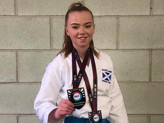 Emma Ruthven is pictured with her two British Championship kata medals