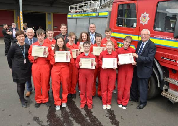 North Lanarkshire Council leader Jim Logue (right) hands out the Fireskills awards to pupils from Glencryan Primary