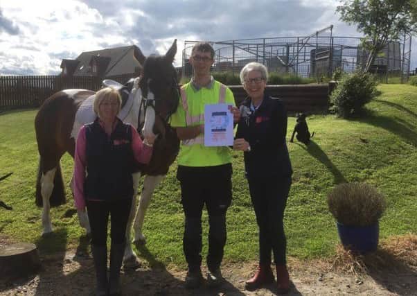 Jennifer Dixon-Clegg (right) from the British Horse Society presents Christopher Duncan with his awards, joined by Tannoch Stables founder Dawn Harrison