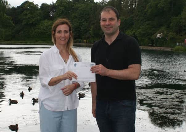 C3 Chair Roy Provan receiving the generous donation from Laura Malloy, President of East Renfrewshire Chamber of Commerce
