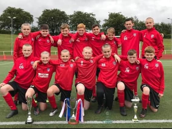 Carluke United under-13 squad with trio of trophies (Submitted pic)