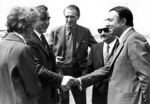 Provost Murray meeting Mayor Sousi of Bron (Cumbernauld's twin town) at an airport (with other officials). 1975