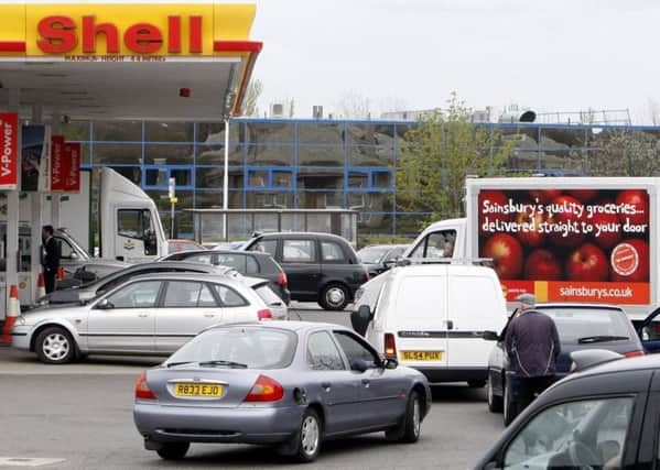 Cars queuing at a Shell garage.