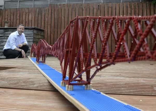 A Scottish civil engineer Michael Dineen with his giant Lego model of the Forth Bridge which measures 4.7m long. (SWNS.COM)