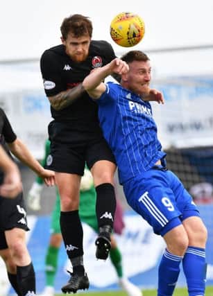 Scott Rumsby wins an aerial duel with Peterhead's Rory McAllister (pic: Duncan Brown)