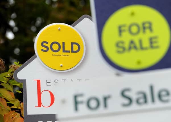File photo dated 14/10/14 of Sold and For Sale signs as house prices across the UK increased at their lowest annual rate in around seven years in July, according to official figures.