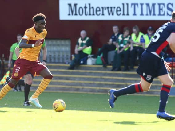 Devante Cole in action for Motherwell, with the Motherwell Times advert in the background at Fir Park!