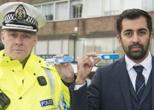 Chief Superintendent Stewart Carle and Justice Secretary Humza Yousaf, holding Drugswipe testing kits, have welcomed the new laws.  (Photo: Neil Hanna)