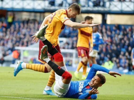 James Tavernier hits the deck after collision with Liam Polworth (Pic by Ian McFadyen)