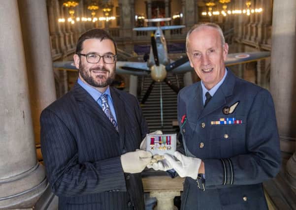Glasgow Museums curator John Messner (L) and Squadron Leader  Archie McCallum of the 602 City of Glasgow Squadron unveil the new display. (Photo by Bill Murray / SNS Group)