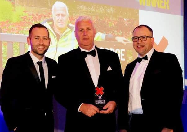 George Duff (centre) is pictured receiving his First Aid Hero of the Year Award.