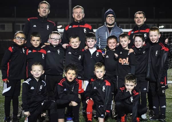 Amazon visit to Cleland Boys' Club football team, pictured with the team are (l-r): 

coaches John and James Townsley, Amazon's Stephen Weir and coach Stuart McPherson.

Pic© Andy Buchanan