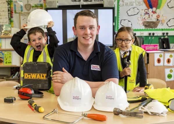 Taylor Wimpey representative Fraser Martin gives the kids a talk on tools of the trade and of Health and Safety as part of their Skills Academy.