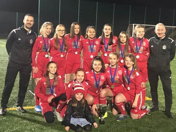 Graeme Winning (1st left) is pictured with the title-winning Kirkfield United under-13 girls squad and fellow coach Damian Murphy (Submitted pic)