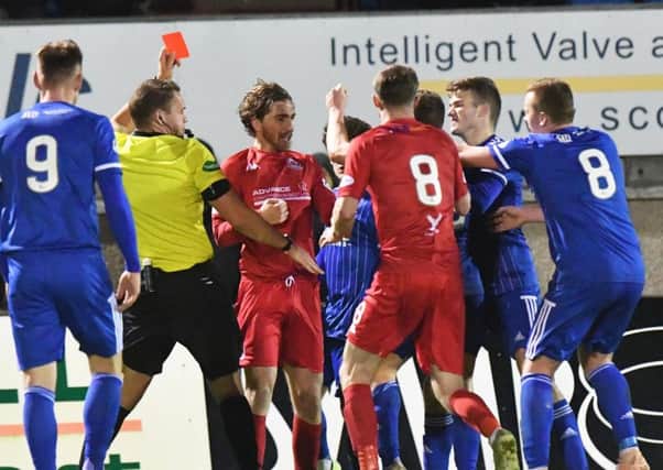 Referee Chris Graham shows red to Peterhead's Simon Ferry as tempers fray (pic: Duncan Brown)