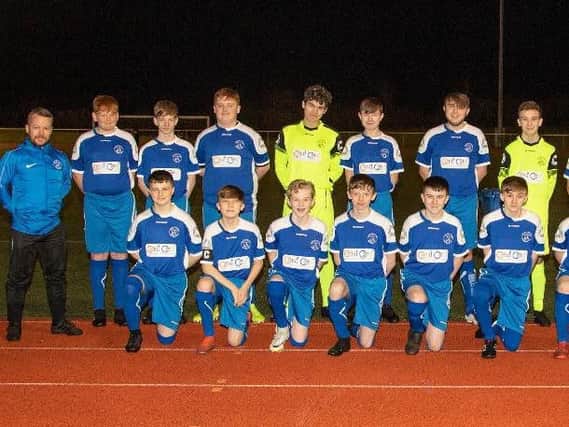 Head coach Paul Skelton (1st left) is pictured with some of the Carluke Rovers Youth Academy 2005s squad, sponsored by OMNI Interior Solutions and OMNI core drilling specialists.