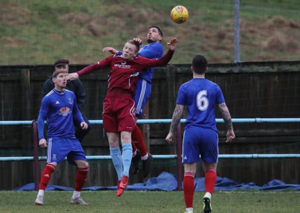 Ian Smith, Cumbernauld United's new signing from Stranraer, in an aerial battle with Darvel's Allan McKenzie (pic: Stewart Attwood)